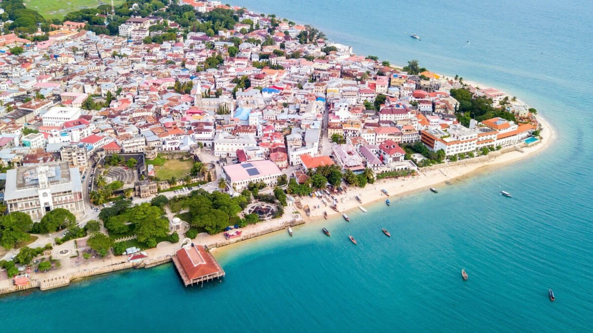 Aerial view of Stone Town Zanzibar showing historic buildings and the Indian Ocean coastline.