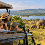Family enjoying a wildlife safari in Akagera National Park, Rwanda, watching elephants, zebras and giraffes.