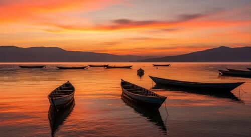 Boat travelling across Lake Kivu at sunset with scenic hills in the background, Rwanda.