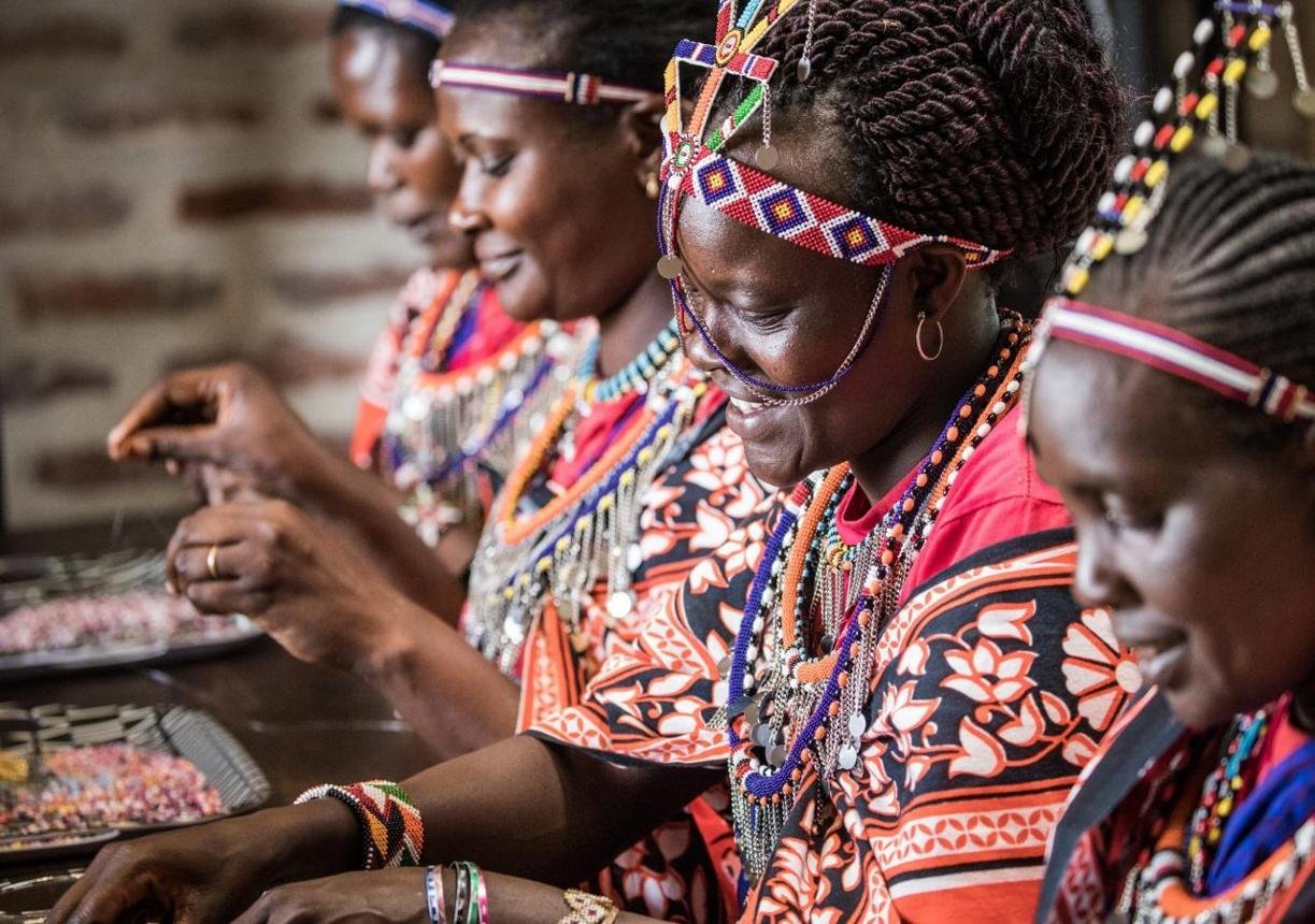 Maasai women creating colourful handmade beadwork and jewellery at a beading studio in Kenya.
