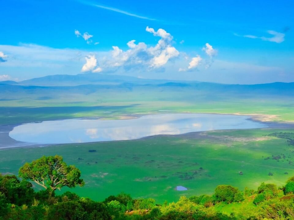 Panoramic view of Ngorongoro Crater in Tanzania, surrounded by green volcanic highlands.