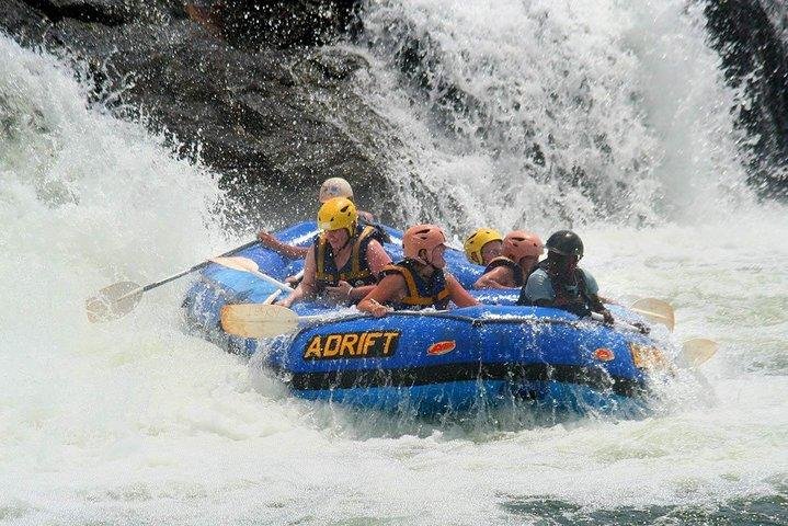 Visitors enjoying a calmer rafting section of the Nile with green riverbanks near Jinja