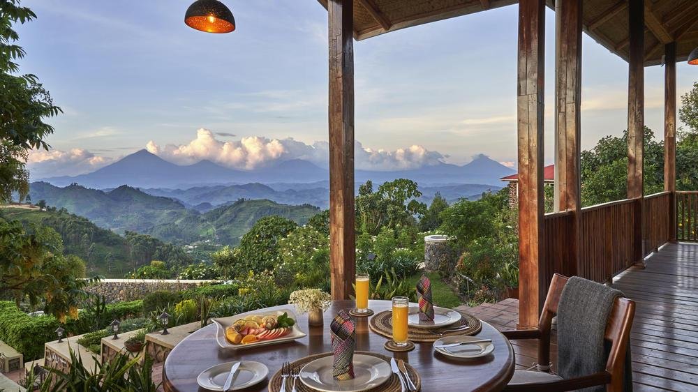 Nkuringo Bwindi Gorilla Lodge overlooking forested hills and Virunga volcanoes