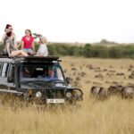 Private vs Shared Safari Tanzania comparison showing tourists in a safari vehicle in the Serengeti.