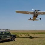 Tanzania Fly-In vs Road Safari comparison showing a safari aircraft and Land Cruiser in the Serengeti.