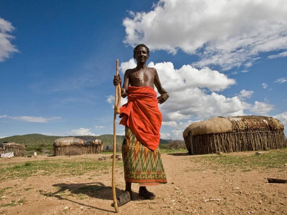 Maasai people wearing traditional clothing during a cultural village visit in Kenya.